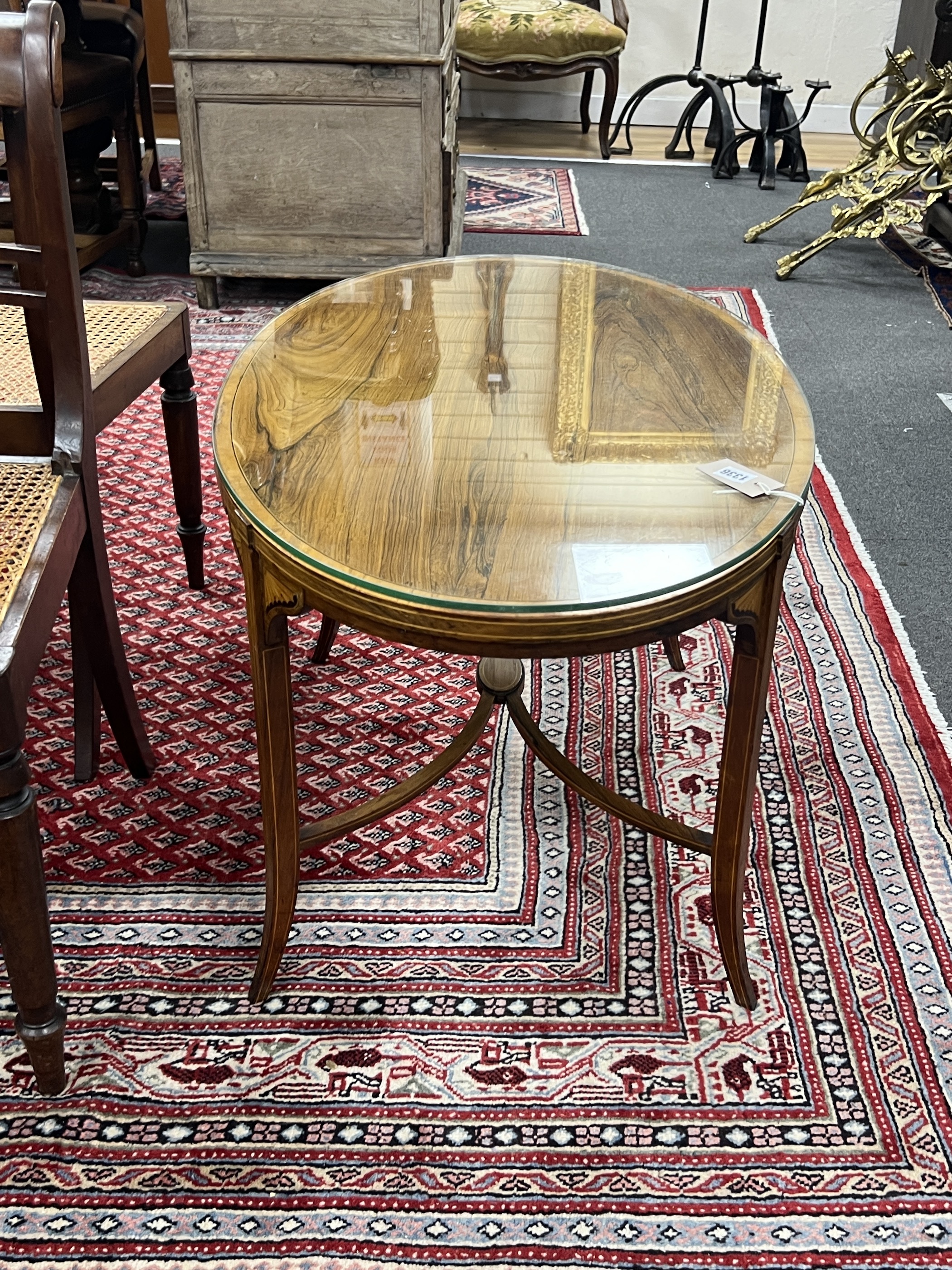 An Edwardian Schoolbred & Co. oval banded rosewood low occasional table converted from an etagere, width 88cm, depth 55cm, height 50cm